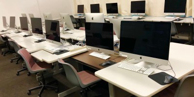 Photo of computers on desks.