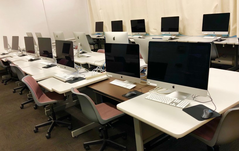 Photo of computers on desks.